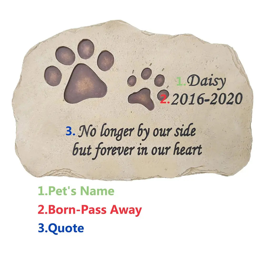 Garden setting with PawVault pet memorial stone among flowers – PawVault